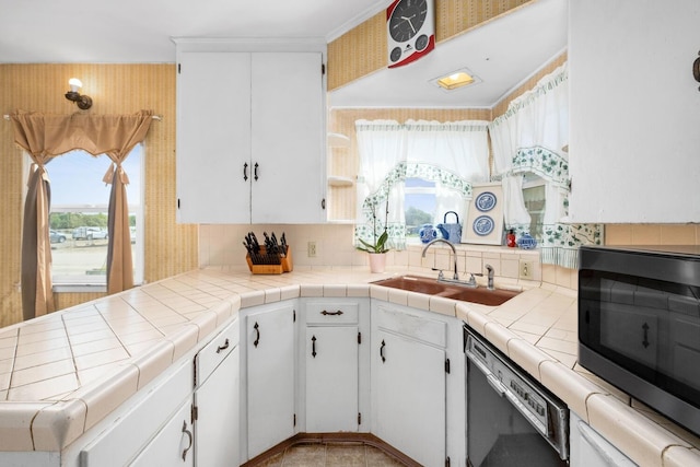 kitchen featuring white cabinetry, sink, tile countertops, and dishwashing machine