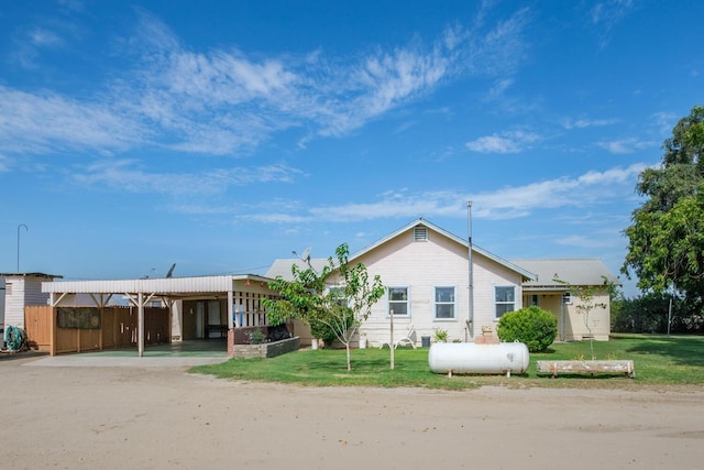 view of front facade with a carport and a front lawn