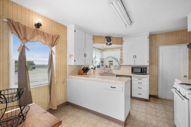 kitchen with white cabinetry, light tile patterned floors, and tile countertops