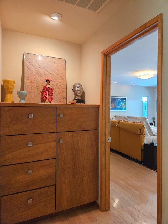 hallway with light hardwood / wood-style floors