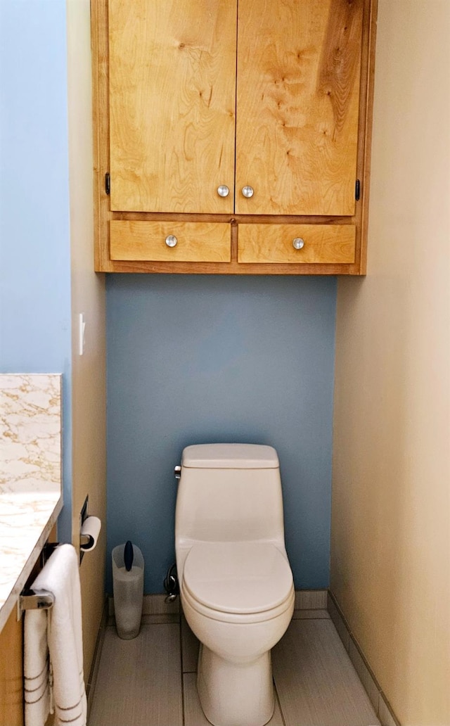 bathroom featuring tile patterned floors, vanity, and toilet