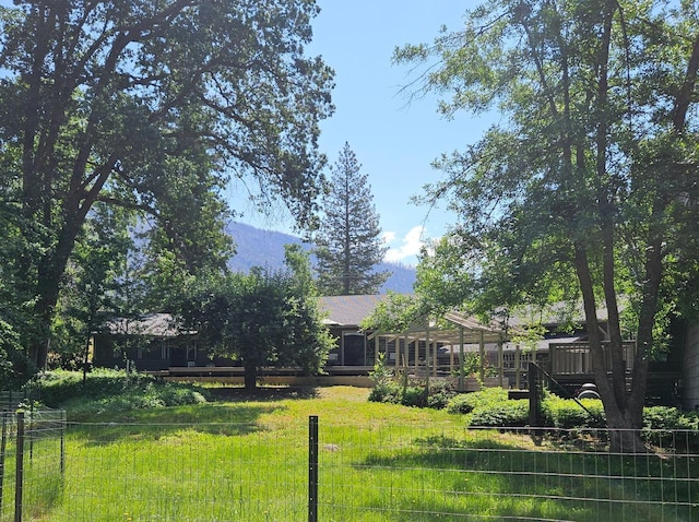 view of yard with a deck with mountain view