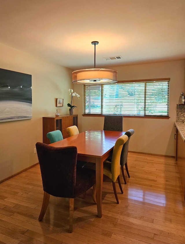 dining room with plenty of natural light and light wood-type flooring