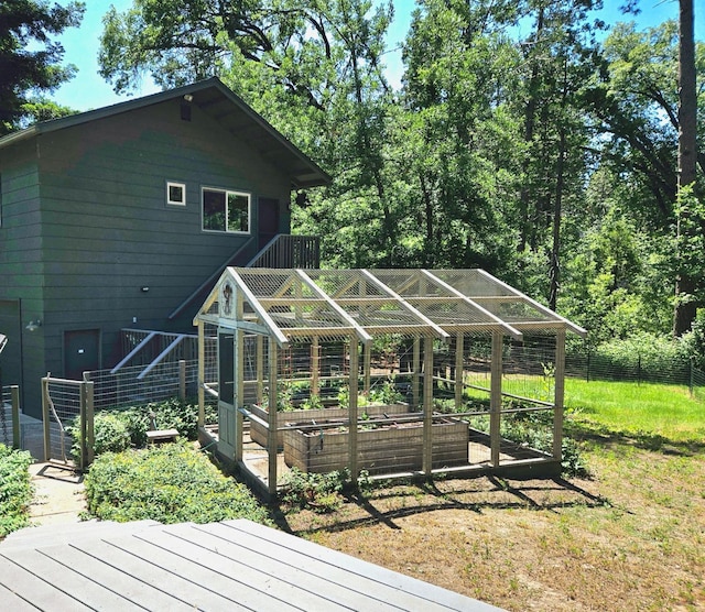 wooden deck with an outdoor structure and a yard