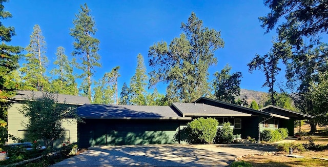 view of home's exterior featuring a garage and a mountain view