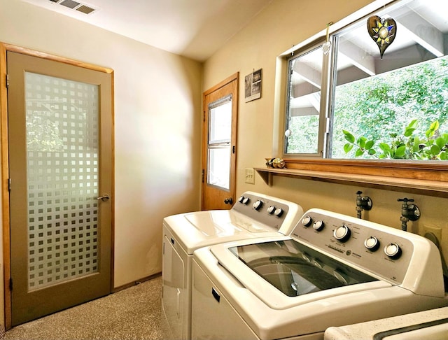 clothes washing area featuring washer and dryer