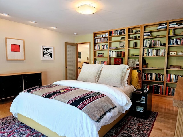 bedroom with hardwood / wood-style floors