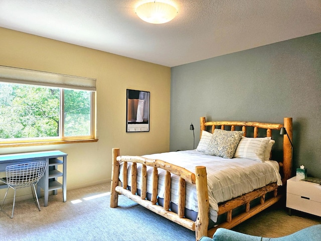 carpeted bedroom with a textured ceiling