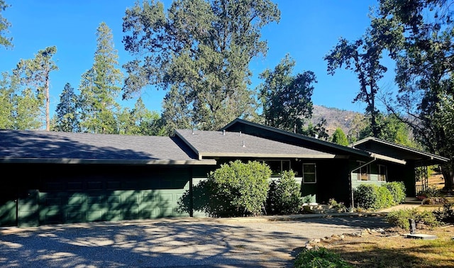 view of side of property with a garage and a mountain view