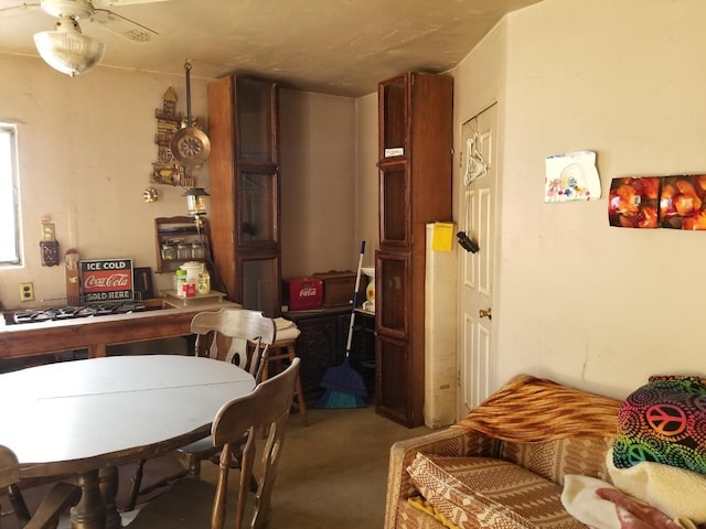 dining room with light carpet and ceiling fan