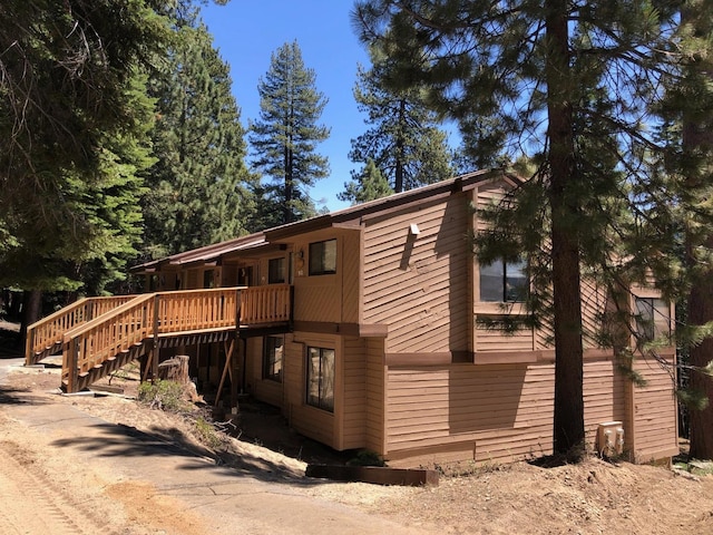 back of house with a deck