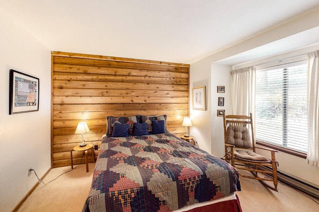 carpeted bedroom featuring wooden walls