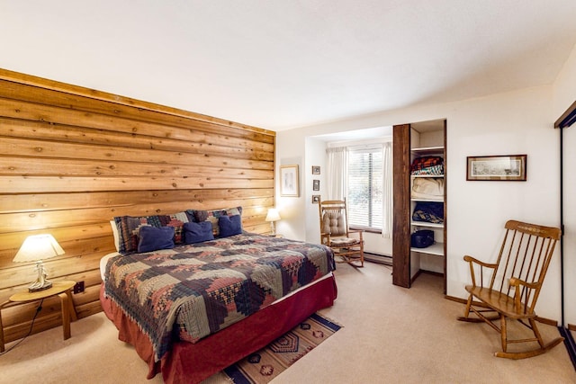 carpeted bedroom with a baseboard heating unit and wood walls