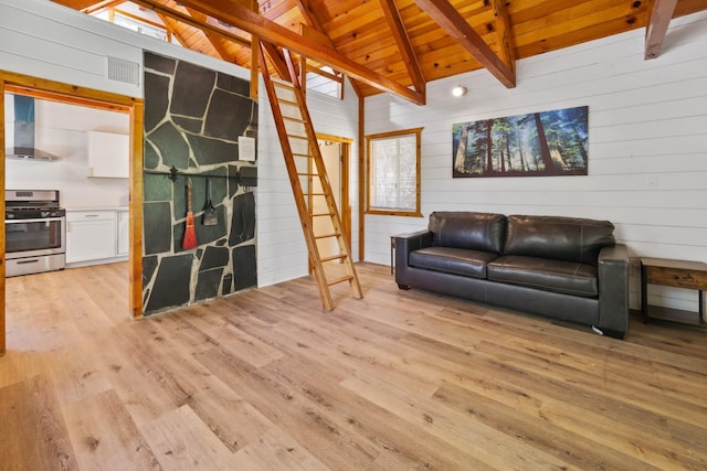 living room with lofted ceiling with beams, wood walls, light hardwood / wood-style flooring, and wooden ceiling