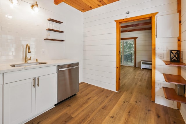 kitchen featuring light hardwood / wood-style floors, sink, dishwasher, and white cabinets