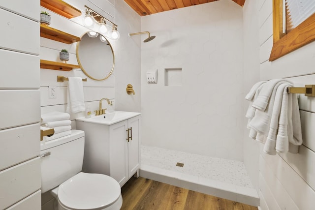 bathroom featuring vanity, tiled shower, hardwood / wood-style flooring, wooden ceiling, and toilet