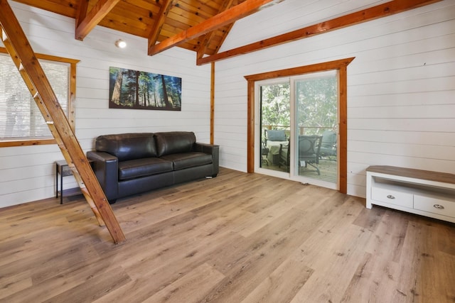 living area featuring light hardwood / wood-style floors, wooden walls, wooden ceiling, and vaulted ceiling with beams