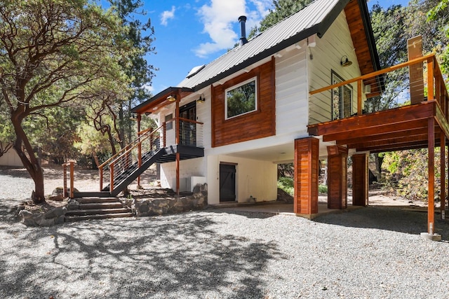 rear view of house featuring a carport