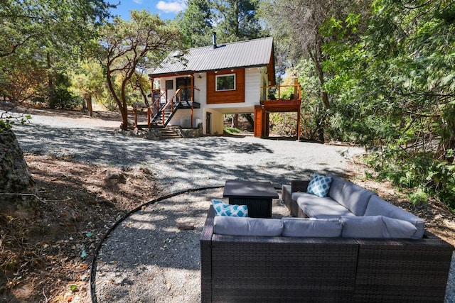 back of property featuring a wooden deck and outdoor lounge area