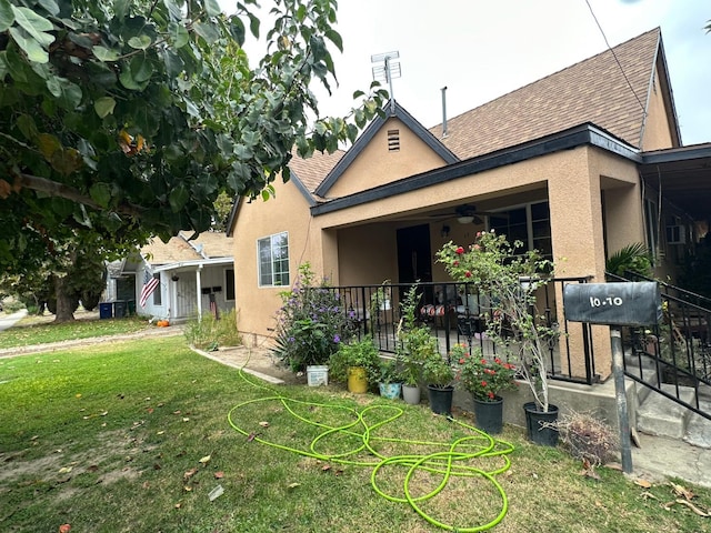 rear view of house featuring a yard