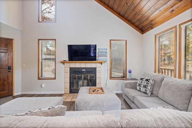 living room with high vaulted ceiling, wood ceiling, a fireplace, and light hardwood / wood-style floors