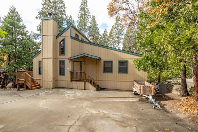 rear view of property featuring central AC unit and a patio area