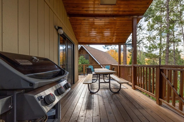 wooden deck featuring a grill