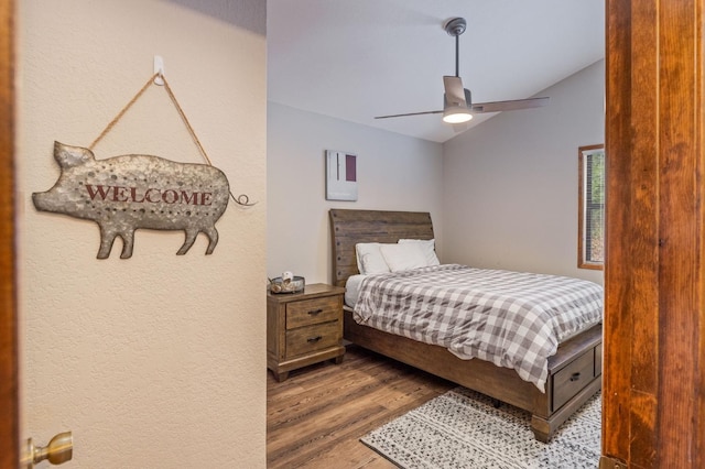 bedroom featuring wood-type flooring, lofted ceiling, and ceiling fan