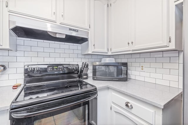 kitchen featuring decorative backsplash, white cabinets, and black appliances