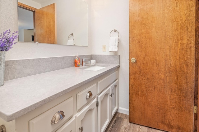 bathroom featuring vanity and wood-type flooring