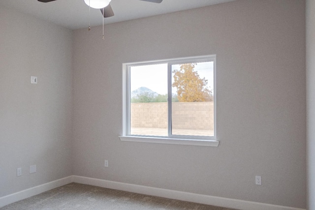 spare room with light carpet and ceiling fan