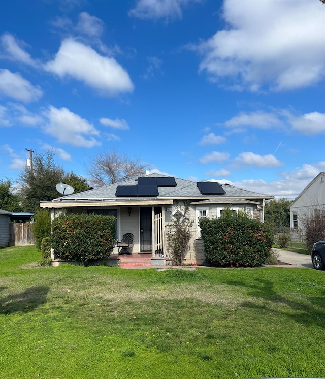 exterior space with solar panels and a yard