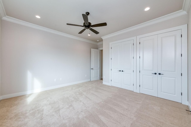 unfurnished bedroom with recessed lighting, crown molding, baseboards, and two closets