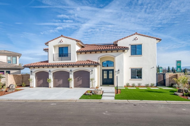 mediterranean / spanish house with french doors, stucco siding, a front yard, fence, and a balcony