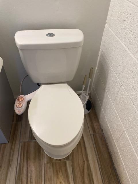 bathroom featuring hardwood / wood-style floors and toilet