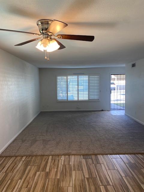 spare room featuring ceiling fan and dark hardwood / wood-style flooring