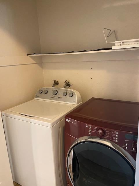 clothes washing area featuring washing machine and dryer and hookup for a washing machine