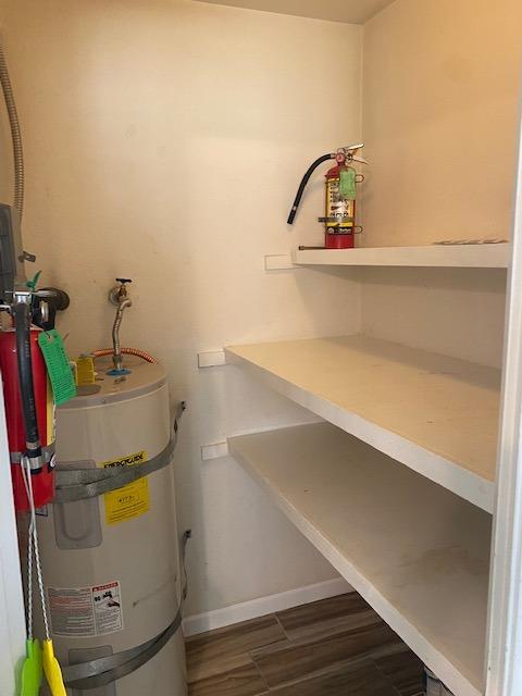 utility room featuring water heater