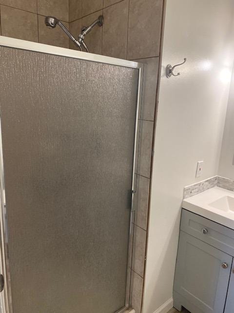 bathroom featuring an enclosed shower and vanity