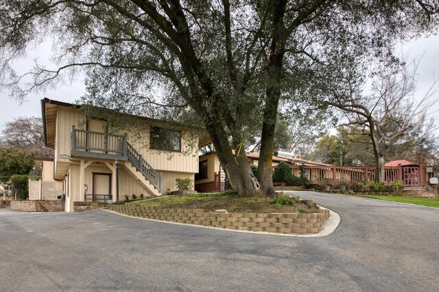 view of front facade featuring aphalt driveway and stairs