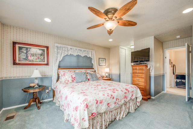 bedroom with a closet, recessed lighting, wallpapered walls, and carpet floors