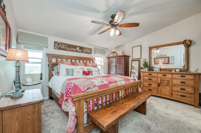 bedroom with light colored carpet, a ceiling fan, and vaulted ceiling
