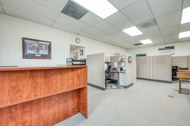 office area with visible vents, a paneled ceiling, and light colored carpet