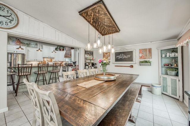dining area featuring vaulted ceiling, light tile patterned floors, and a chandelier