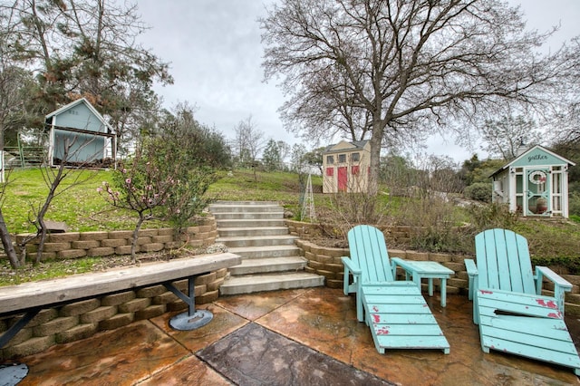 view of patio / terrace featuring stairway, an outbuilding, and a shed