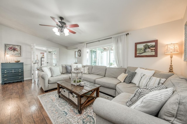 living room featuring hardwood / wood-style floors, vaulted ceiling, and ceiling fan