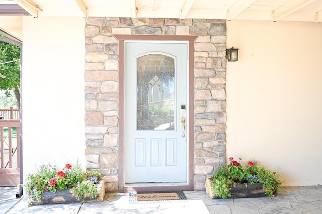 doorway to property with stone siding