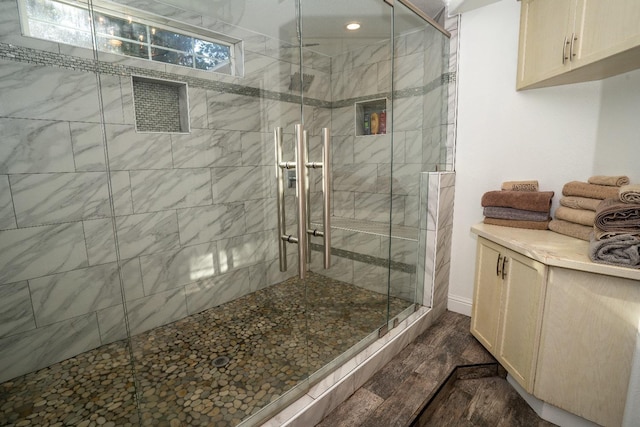 bathroom featuring hardwood / wood-style flooring and an enclosed shower