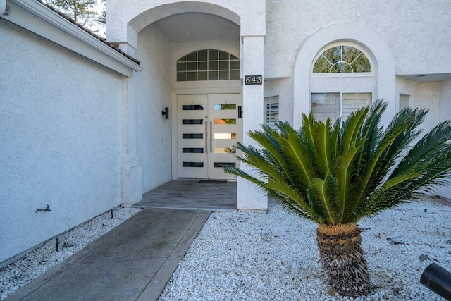 view of exterior entry featuring french doors