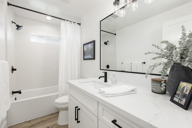 full bathroom featuring vanity, toilet, hardwood / wood-style floors, and shower / bath combo with shower curtain